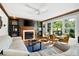 Cozy living room featuring a fireplace, built-in shelves, and large windows with natural light at 737 Dushea Nw Ct, Kennesaw, GA 30144