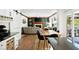 Open concept living space with a fireplace, dining area, and kitchen with ample storage at 737 Dushea Nw Ct, Kennesaw, GA 30144