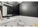 Powder room with black walls, white wainscoting, and modern fixtures at 1819 Walker Ridge Sw Dr, Marietta, GA 30064
