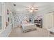 Charming bedroom featuring a bed with a patterned comforter, complemented by stylish decor and a ceiling fan at 1819 Walker Ridge Sw Dr, Marietta, GA 30064