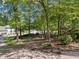 Long driveway leading to a charming home surrounded by mature trees and natural landscaping at 1819 Walker Ridge Sw Dr, Marietta, GA 30064