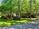 A house surrounded by lush, green trees and manicured landscaping at 1819 Walker Ridge Sw Dr, Marietta, GA 30064