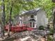 Aerial view of a backyard with a two-story home, red deck, and mature trees at 1819 Walker Ridge Sw Dr, Marietta, GA 30064