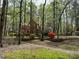 A glimpse of the home's facade through towering trees at 1819 Walker Ridge Sw Dr, Marietta, GA 30064