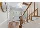 Bright foyer with hardwood floors and staircase leading to upper level with front door view at 1819 Walker Ridge Sw Dr, Marietta, GA 30064