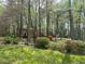 Beautiful lush front yard of a traditional home with mature trees and landscaped gardens at 1819 Walker Ridge Sw Dr, Marietta, GA 30064