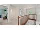 Upstairs hallway with wood railing, light neutral walls, and views into the bedrooms at 1819 Walker Ridge Sw Dr, Marietta, GA 30064