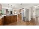 Spacious kitchen featuring stainless steel refrigerator, hardwood floors, and a breakfast bar at 1819 Walker Ridge Sw Dr, Marietta, GA 30064