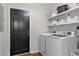 Bright laundry room featuring a modern washer and dryer, storage shelves, and convenient access to the outside at 1819 Walker Ridge Sw Dr, Marietta, GA 30064