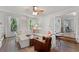 Bright living room with hardwood floors, white sofa, and windows providing lots of natural light at 1819 Walker Ridge Sw Dr, Marietta, GA 30064