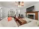 Bright open living room with fireplace, hardwood floors, and a white sofa with throw pillows at 1819 Walker Ridge Sw Dr, Marietta, GA 30064
