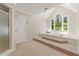 Elegant soaking tub area with large windows, a separate shower, and bright natural light at 1819 Walker Ridge Sw Dr, Marietta, GA 30064