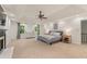 Bright main bedroom featuring a fireplace, dual windows, and a ceiling fan at 1819 Walker Ridge Sw Dr, Marietta, GA 30064