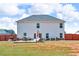 Large backyard featuring a patio with furniture, offering ample space for outdoor activities at 206 Prescott St, Locust Grove, GA 30248