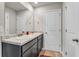 Bright bathroom featuring double vanity with granite countertop and white cabinets at 206 Prescott St, Locust Grove, GA 30248
