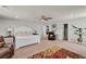 Spacious main bedroom featuring neutral carpet, ceiling fan, and furnishings at 206 Prescott St, Locust Grove, GA 30248