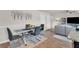 Open-concept dining area with modern glass table and stylish chairs at 206 Prescott St, Locust Grove, GA 30248