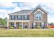 Charming two-story brick home with a well-manicured lawn and inviting front porch at 206 Prescott St, Locust Grove, GA 30248