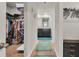 Hallway between closet and bath with wood floors and area rugs at 206 Prescott St, Locust Grove, GA 30248