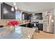 Gourmet kitchen featuring granite countertops, stainless steel appliances, and dark wood cabinets at 206 Prescott St, Locust Grove, GA 30248
