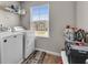 Convenient laundry room equipped with modern washer and dryer units, plus overhead shelving at 206 Prescott St, Locust Grove, GA 30248