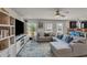 Spacious living room with a large sectional sofa, ceiling fan, and a built-in entertainment center at 206 Prescott St, Locust Grove, GA 30248