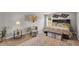 Stylishly decorated main bedroom with king bed, accent wall, and sitting area at 206 Prescott St, Locust Grove, GA 30248