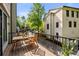 Balcony with a wood table and chairs overlooking a street and other buildings at 217 Knob Hills Cir, Decatur, GA 30030