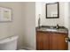 Half bath features granite counters and a decorative mirror at 217 Knob Hills Cir, Decatur, GA 30030