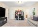 Bonus room with a comfy couch, television, neutral walls and carpet, and storage shelves at 217 Knob Hills Cir, Decatur, GA 30030
