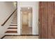 Entryway with a wooden front door, tile floors, staircase, and an open view of the hallway with interior doors at 217 Knob Hills Cir, Decatur, GA 30030