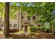Exterior of multi-story townhouse with brick facade, well-maintained landscaping, and a covered front entrance at 217 Knob Hills Cir, Decatur, GA 30030