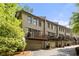 Multi-level townhome featuring private balconies over garages in a lush green community at 217 Knob Hills Cir, Decatur, GA 30030