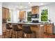 Bright kitchen featuring granite countertops, wood cabinets, hardwood flooring, and a breakfast bar with seating for three at 217 Knob Hills Cir, Decatur, GA 30030