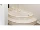 Corner soaking tub with marble surround and two steps up at 4391 Sandy Plains Rd, Marietta, GA 30066