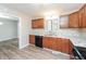 A kitchen with wood cabinets, black appliances, tile countertops, and wood-look floors at 4391 Sandy Plains Rd, Marietta, GA 30066