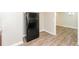 This kitchen shows a black refrigerator, light walls, and wood-look flooring at 4391 Sandy Plains Rd, Marietta, GA 30066