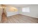A room with wood-look floors, neutral walls, and natural light from a large window at 4391 Sandy Plains Rd, Marietta, GA 30066