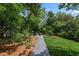 Lush backyard featuring a stone firepit area, gravel walkway, and well-maintained lawn, perfect for outdoor relaxation at 132 Olympic Pl, Decatur, GA 30030