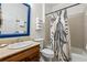Bathroom featuring a tiled shower/tub, vanity with cream marble countertop, and unique shower curtain at 132 Olympic Pl, Decatur, GA 30030