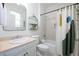 Bright bathroom with white tiled shower, unique shower curtain, vanity with a marble countertop, and modern decor at 132 Olympic Pl, Decatur, GA 30030