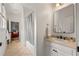 Bathroom featuring vanity with cream marble countertop, and shower/tub, conveniently located near the living area at 132 Olympic Pl, Decatur, GA 30030