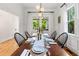 A dining room with a table set with plates and glasses, and a decorative centerpiece at 132 Olympic Pl, Decatur, GA 30030