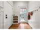 A tidy entryway with coat hooks, storage, and a light-filled glass door at 132 Olympic Pl, Decatur, GA 30030