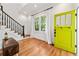 Bright entryway featuring hardwood floors, stylish staircase, a green front door and ample natural light at 132 Olympic Pl, Decatur, GA 30030