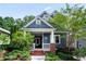 Charming two-story home with landscaped yard, brick steps, a porch swing, and stylish blue siding at 132 Olympic Pl, Decatur, GA 30030