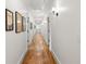 Hallway features hardwood floors, white walls with accent art, and recessed lighting at 132 Olympic Pl, Decatur, GA 30030