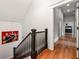 Hallway with staircase and artwork with hardwood floors and neutral paint at 132 Olympic Pl, Decatur, GA 30030