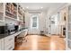 A home office with built-in shelves and cabinets, hardwood floors, and a window at 132 Olympic Pl, Decatur, GA 30030