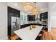 Modern kitchen features black cabinets, stainless steel appliances, and a white island with seating at 132 Olympic Pl, Decatur, GA 30030